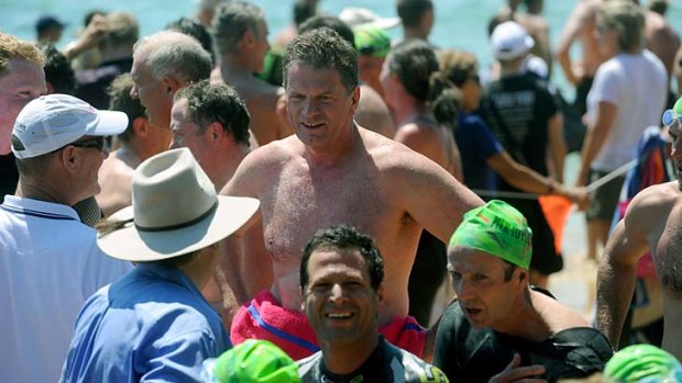 Catching his breath, pink-towelled Premier Ted Baillieu is surrounded by competitors.