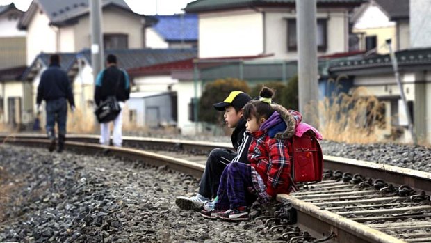 No way home ...  children rest while waiting for evacuation from Ishinomaki.