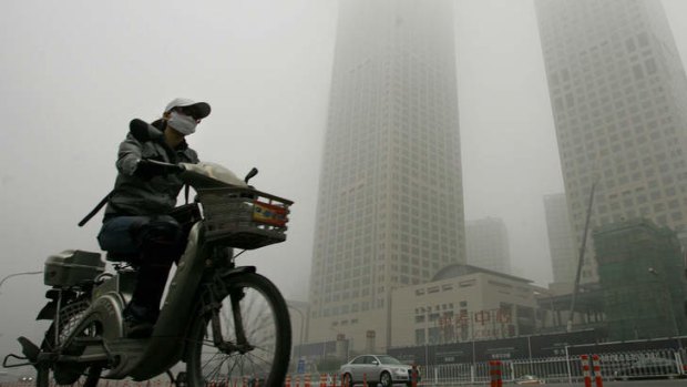 A Beijing cyclist wearing a face mask for prevention from pollution.