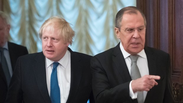Russian Foreign Minister Sergey Lavrov, right, and British Foreign Secretary Boris Johnson enter a hall for their talks in Moscow.