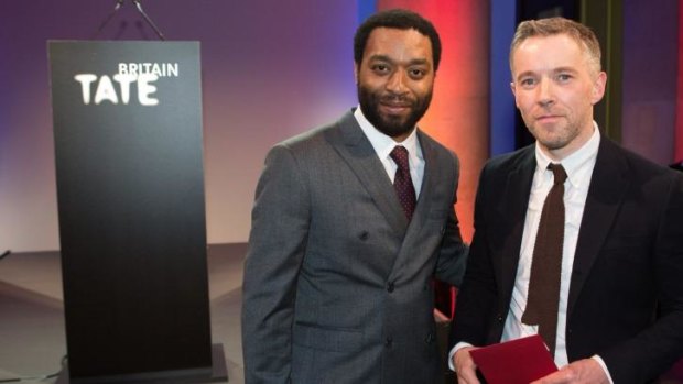 Duncan Campbell, right, with British actor Chiwetel Ejiofor, has won the 2014 Turner Prize for his essay film, <i>It For Others</i>, at Tate Britain.