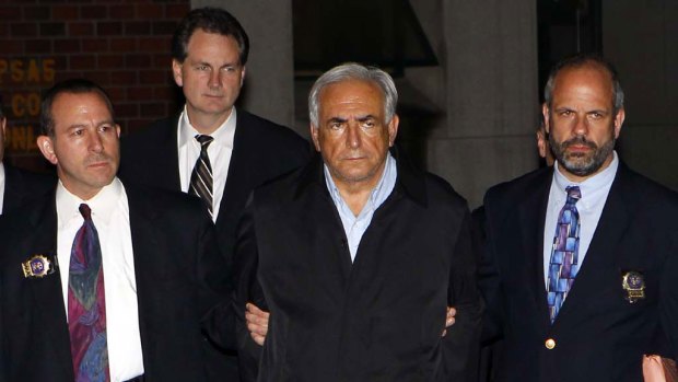 Denies wrongdoing ... Dominique Strauss-Kahn leaves a New York Police Department precinct in handcuffs.