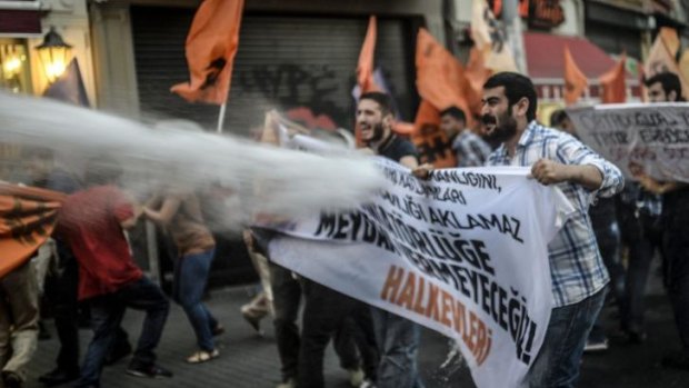 Turkish police use a water cannon as they clash with leftist demonstrators as they protest in Istanbul against new Turkish President Tayyip Erdogan. 