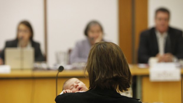 Baby steps...Councillor Nicole Campbell with baby Francoise at yesterday's Senate inquiry into the federal government's paid parental leave scheme.