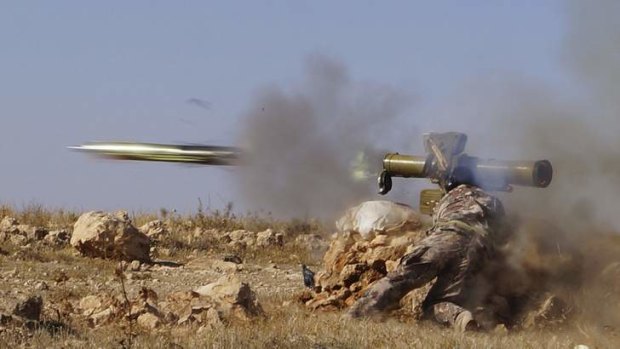 A Free Syrian Army fighter fires an anti-tank missile in the eastern Hama countryside.