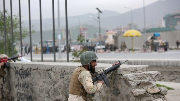 Afghan soldiers take cover during the attack in Kabul.