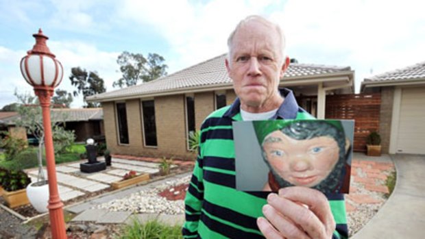 Lyndon Langan with a photo of his missing gnome.