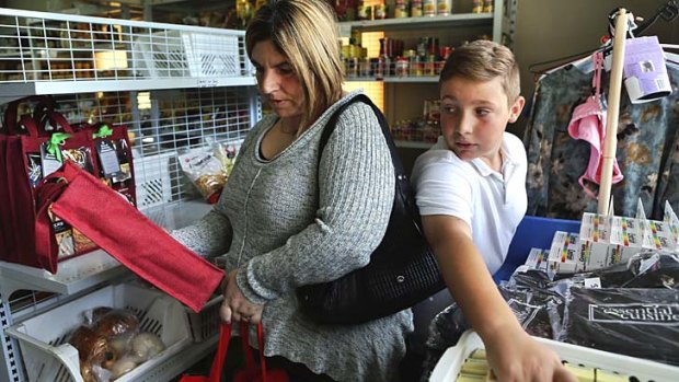 ''I make a dollar stretch as far as I can'': Connie Wilson and her son, Kostya, 11, shop for groceries at Warwick Farm with assistance from The Salvation Army.