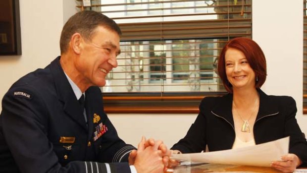 Prime Minister Julia Gillard speaks with Defence Chief Angus Houston.