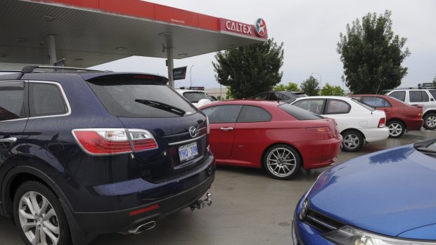 Queues for cheap petrol on Saturday at Woolworths Caltex Majura Park. 