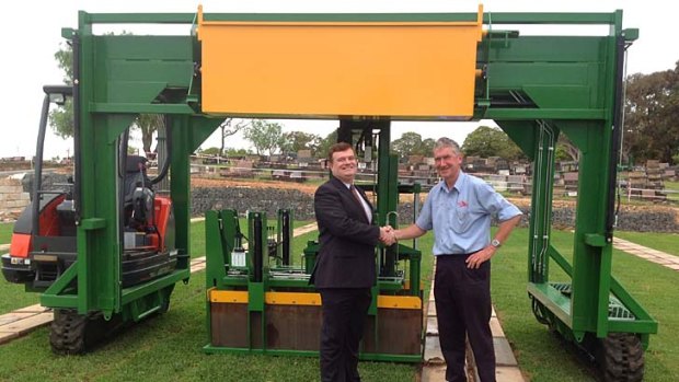 Labour-saver: Woronora chief executive Graham Boyd, left, with Ross George and Austeng's burial lid lifter.