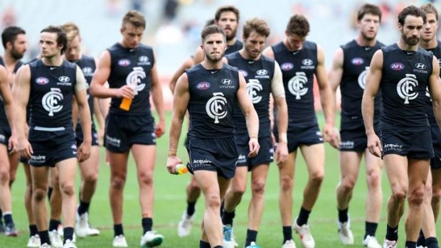 Carlton players trudge off following their defeat at the hands of Melbourne on Saturday.