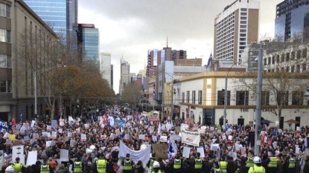 Protesters outside Victoria's parliament house for the Bust the Budget rally on Sunday