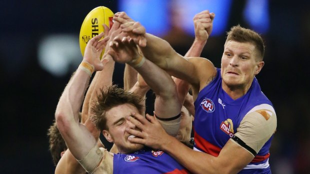 Jordan Roughead of the Bulldogs (left) is crunched by teamate Jack Redpath during the match against Carlton on Saturday.