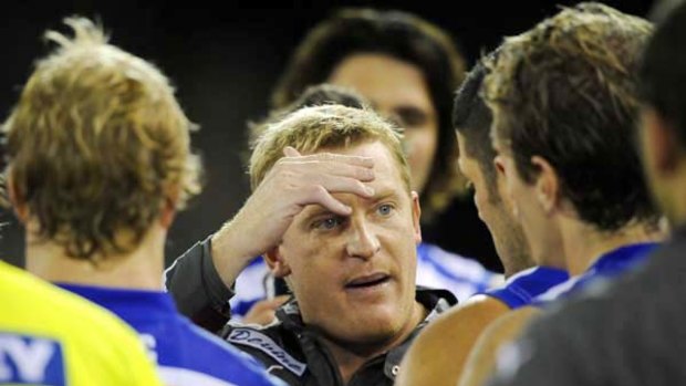 Pressure point: Michael Voss feels the strain as he talks to his players during last week's loss to the Western Bulldogs.