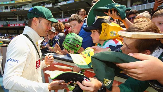 Michael Clarke signs autographs for fans at the Melbourne Cricket Ground after Australia's crushing Second Test defeat of Sri Lanka.