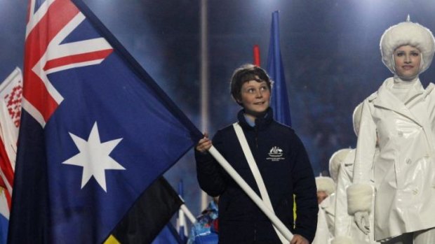 Fourteen-year-old Ben Tudhope carries Australia's flag at the closing ceremony.