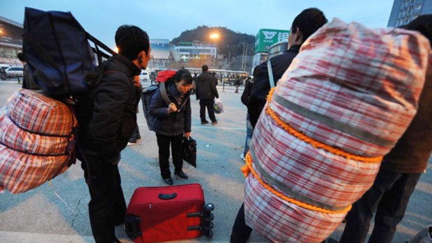 Migrant workers arrive home after their factories closed.