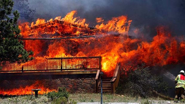 Where there's smoke ... a home is consumed by flames in Colorado in June when fires broke out in a record-breaking heatwave.