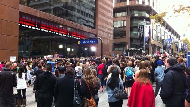 Popular .... fans gather in Martin Place this morning to catch a glimpse of One Direction.