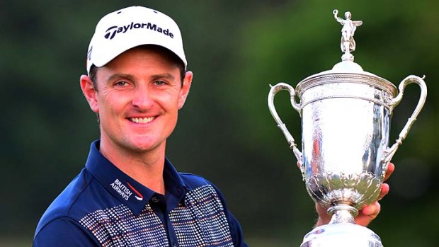 Justin Rose of England celebrates with the U.S. Open trophy.
