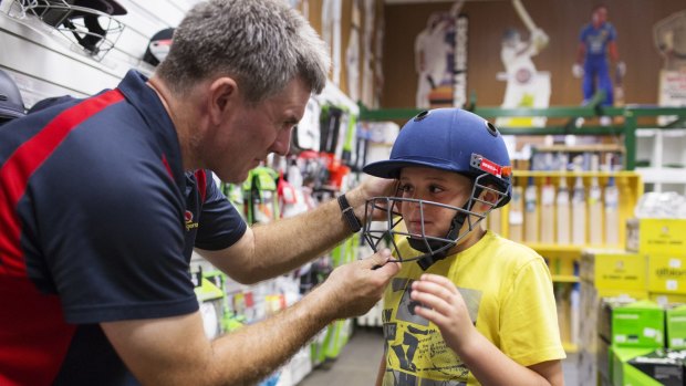 My size: Cooper Sullivan, 9, from Engadine, having his helmet fitted by Geoff Milliken from Kingsgrove Sports Centre.