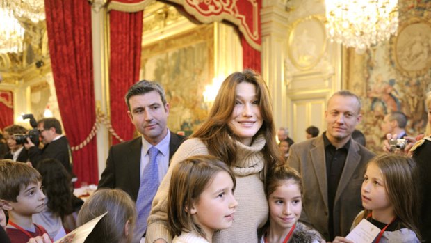 Public appearance ... Carla Bruni brings Christmas cheer to Parisian children.
