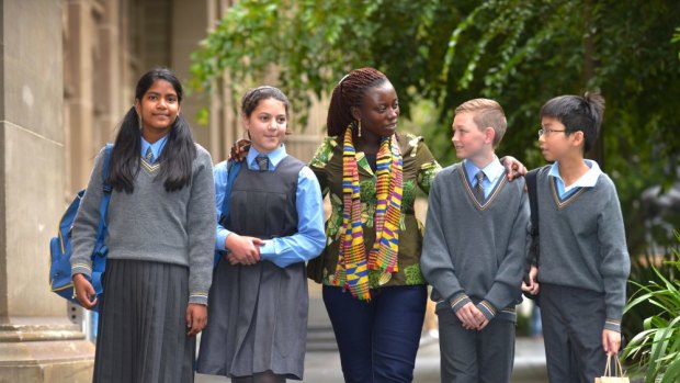 Students from Holy Eucharist Primary School in Malvern East,  (from left to right)  Anna Zabalegui, Laura Mazzarella, Will Slupecki and Bryan Vuong chat with Ghanaian cocoa farmer Esther Ephraim.