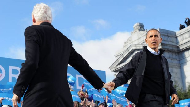History's judgment ... Barack Obama is greeted by the former president Bill Clinton at the end of the campaign.