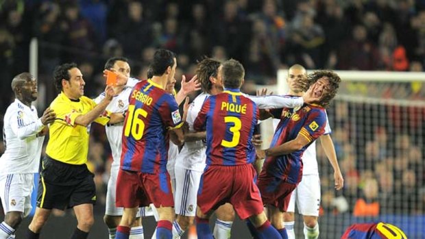 Sergio Ramos of Real Madrid pushes Carles Puyol's face before being sent off for a terrible foul on Lionel Messi.