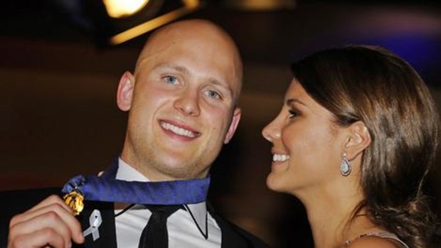 Gary Ablett sports his Brownlow Medal, much to the delight of his girlfriend, Lauren Phillips.