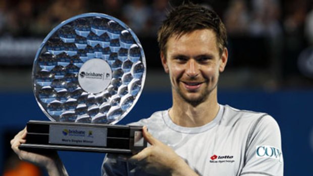 Sweden's Robin Soderling celebrates with the trophy after beating Andy Roddick of the United States in the men's singles final at the Brisbane International.