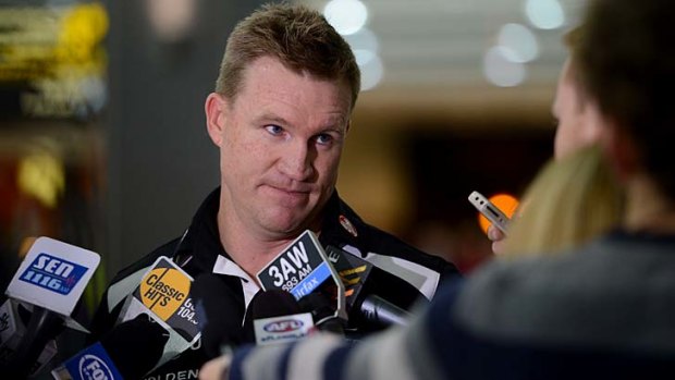 Collingwood coach Nathan Buckley speaking to the media at Tullamarine airport.