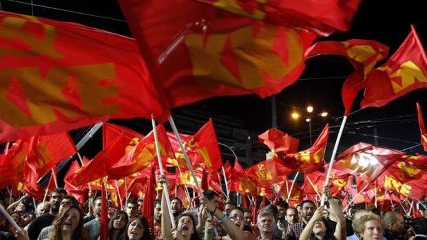 Supporters of the Greek Communist Party wave the party's flags during a rally in Athens.