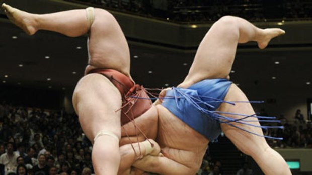Throwdown ... sumo wrestlers Tosayutaka (right) and Toyohibiki grapple in Tokyo. The Japanese sport is dealing with an illegal betting scandal.