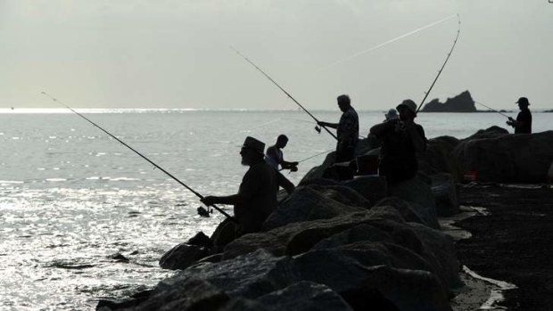 Fishermen on the breakwater at Corrigans Beach, Bateman's Bay on Saturday.