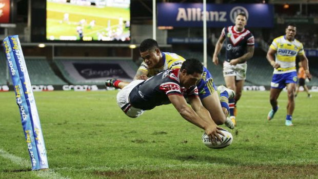 Crossing the line: Roger Tuivasa-Sheck dives to score.