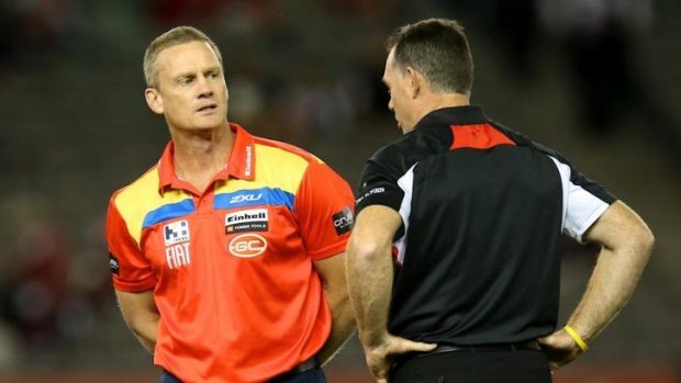 Rival coaches Guy McKenna of the Suns and Alan Richardson of the Saints have a chat before Sunday's game.