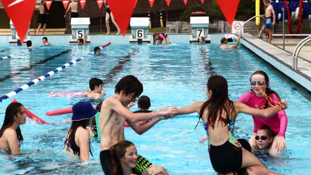 Children having fun in a pool continue a summer tradition.
