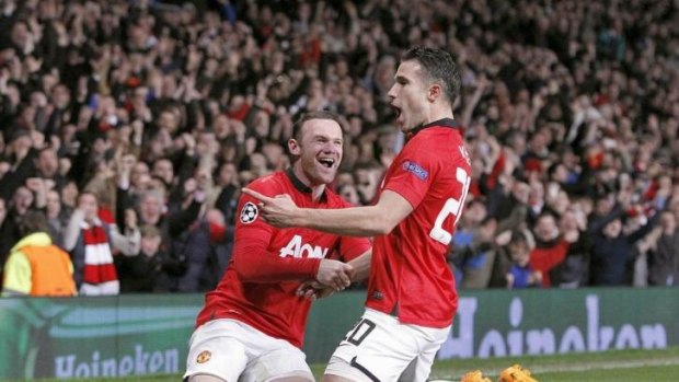 Manchester United's Robin van Persie celebrates with teammate Wayne Rooney.