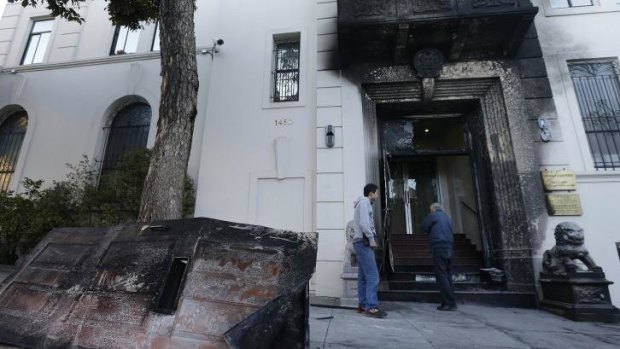 Two men look at the damage to the entrance of the Chinese Consulate in San Francisco. 