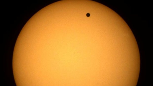 Venus will appear as a black spot.