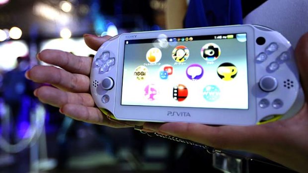 A model holds a Sony Computer Entertainment Inc. PlayStation Vita (PS Vita) portable video game player at the Tokyo Game Show 2013 in Chiba, Japan, on Thursday, Sept. 19, 2013. The Tokyo Game Show runs till Sept. 22. Photographer: Tomohiro Ohsumi/Bloomberg