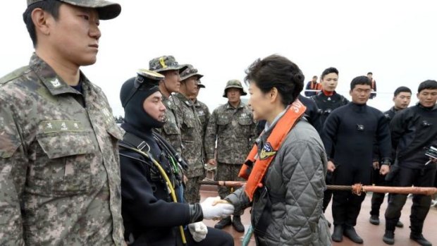 The South Korean President meets a diver at the site where the Sewol ferry sank near Jindo.