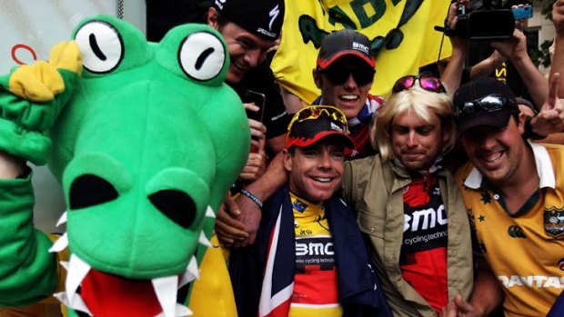 Just when they said it couldn't be done ... a happy and triumphant Cadel Evans and friend on his victory parade in Paris on Sunday.