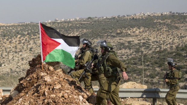 Israeli troops advance toward Palestinian demonstrators near the occupied West Bank village of Aboud, near Ramallah.