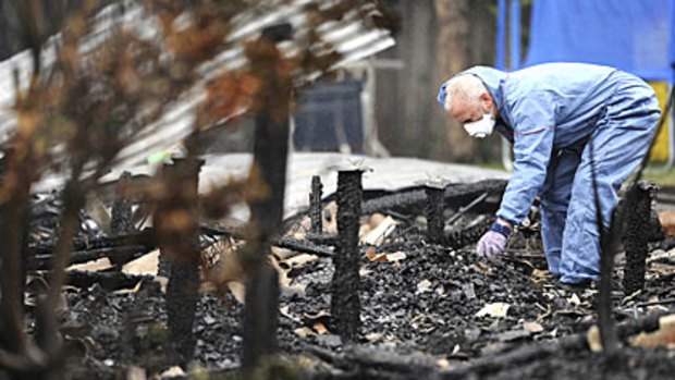 A police investigator at the scene of last night's house fire at Clifton Springs.