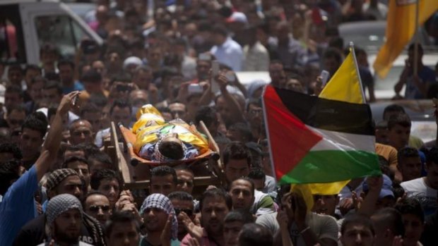Palestinians mourners carry the body of Mohammed Dudin, 15, during his funeral in the village of Dura.