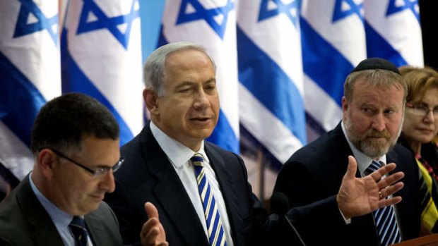 Israel's Prime Minister Benjamin Netanyahu, centre, speaks during the weekly cabinet meeting in Jerusalem.