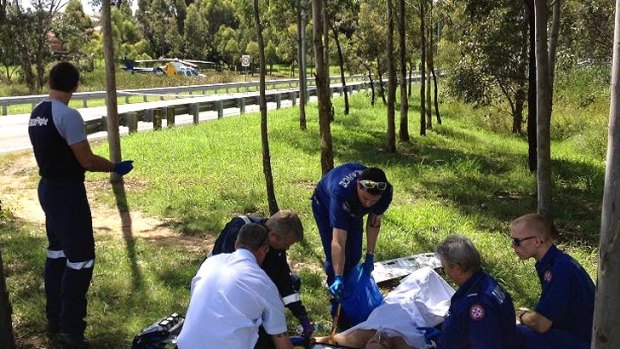 Paramedics and CareFlight doctors treat one of the men shot in Miller this afternoon.